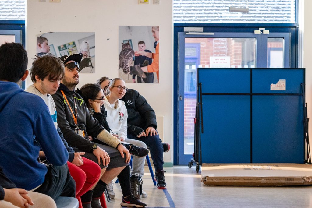 A row of students looking patiently up.