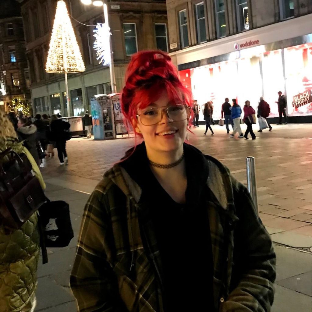 Marie stood in front of Christmas lights in Glasgow