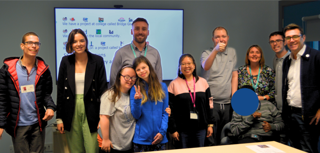 A photo showing Bridge College students and staff standing alongside Andy Burnham