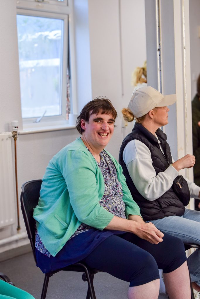 A woman is smiling widely into the camera.