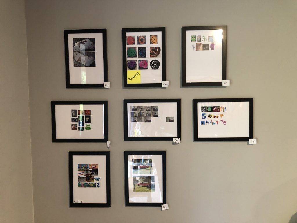 a selection of artworks hung on a wall