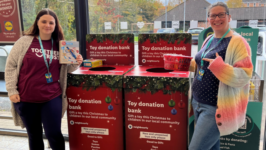 Sarah and Lucy from fundraising stood next to Tesco's toy donation banks