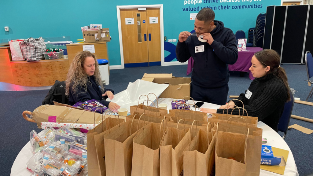 volunteers helping wrap presents