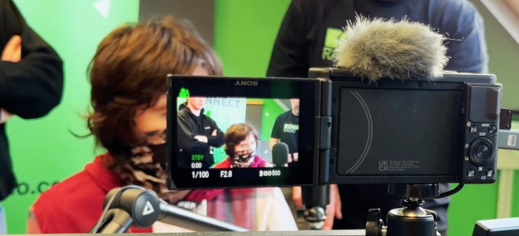 A video camera filming a student.
