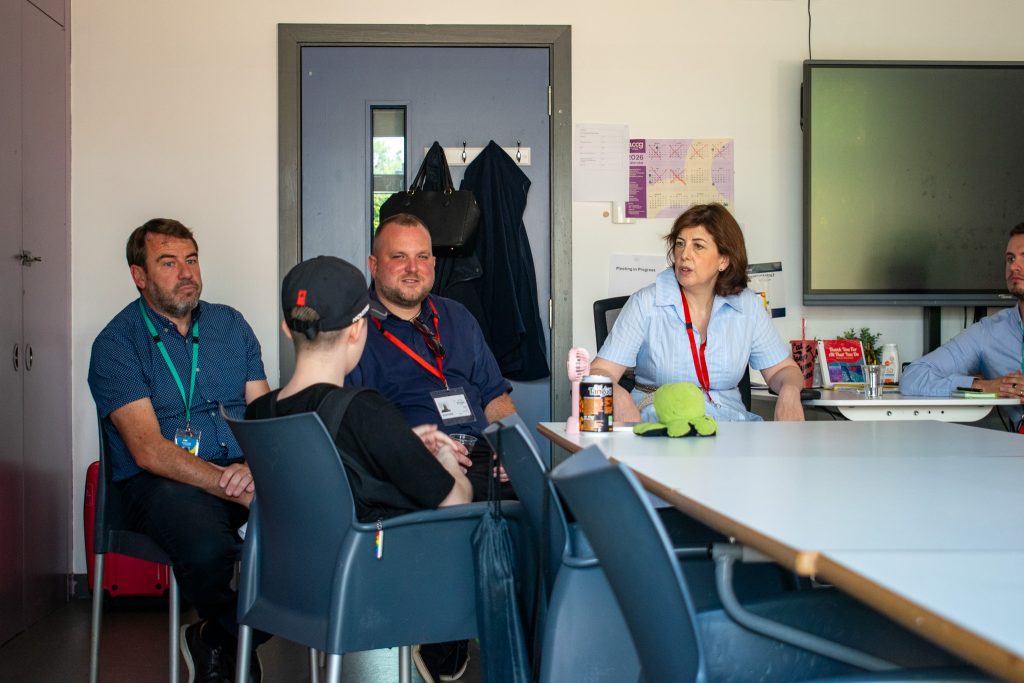 Bridge College principal John Cannon, next to Lucy powell mp and Thomas robinson councillor listening to a student talk