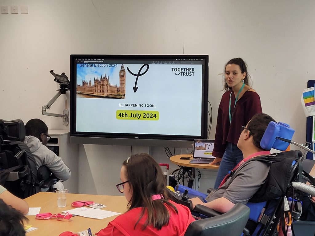 Styliana in front of a screen that reads "next election is on 4 july" 