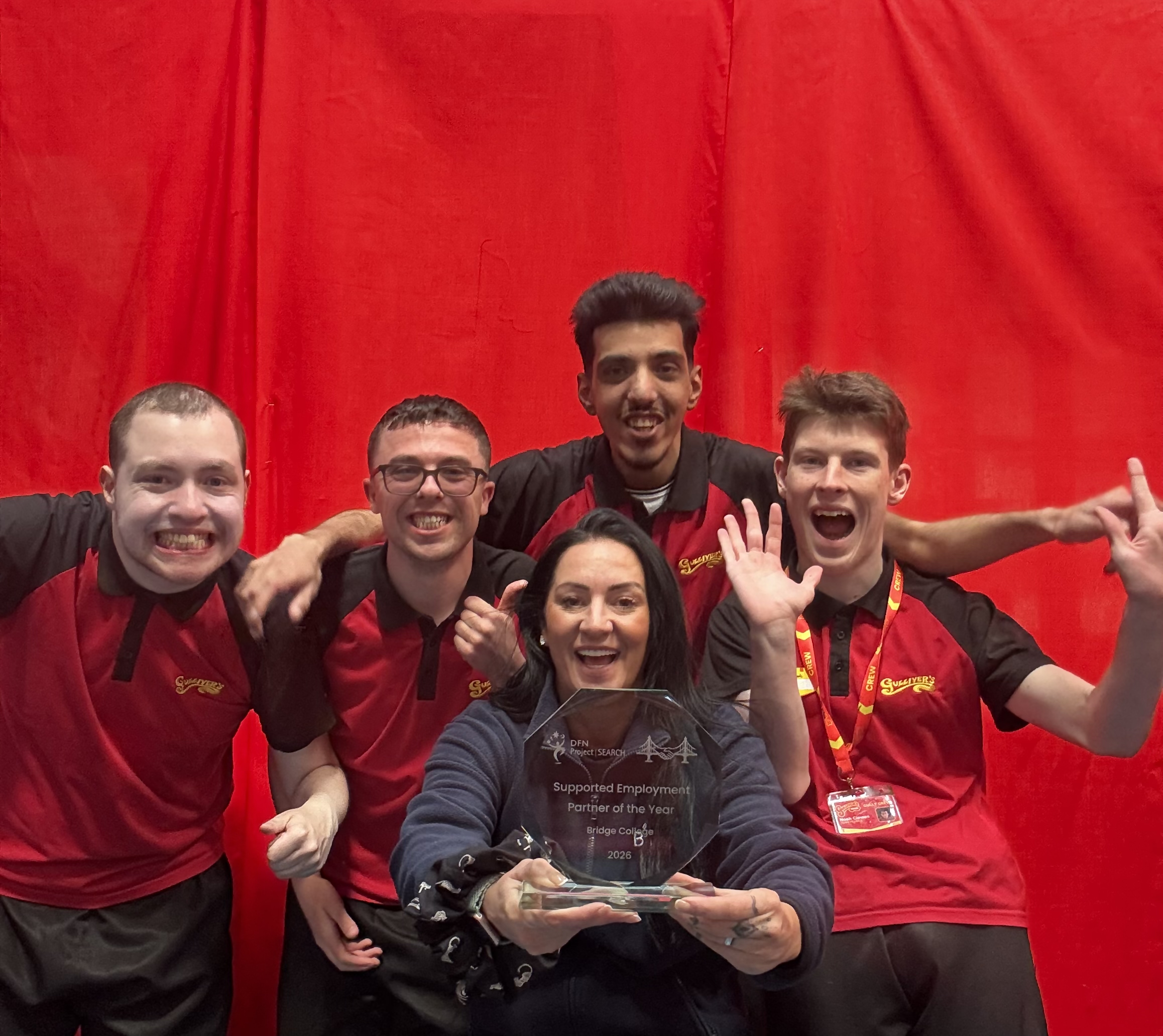 A group of intern celebrating with the Supported Internship lead that they won an award