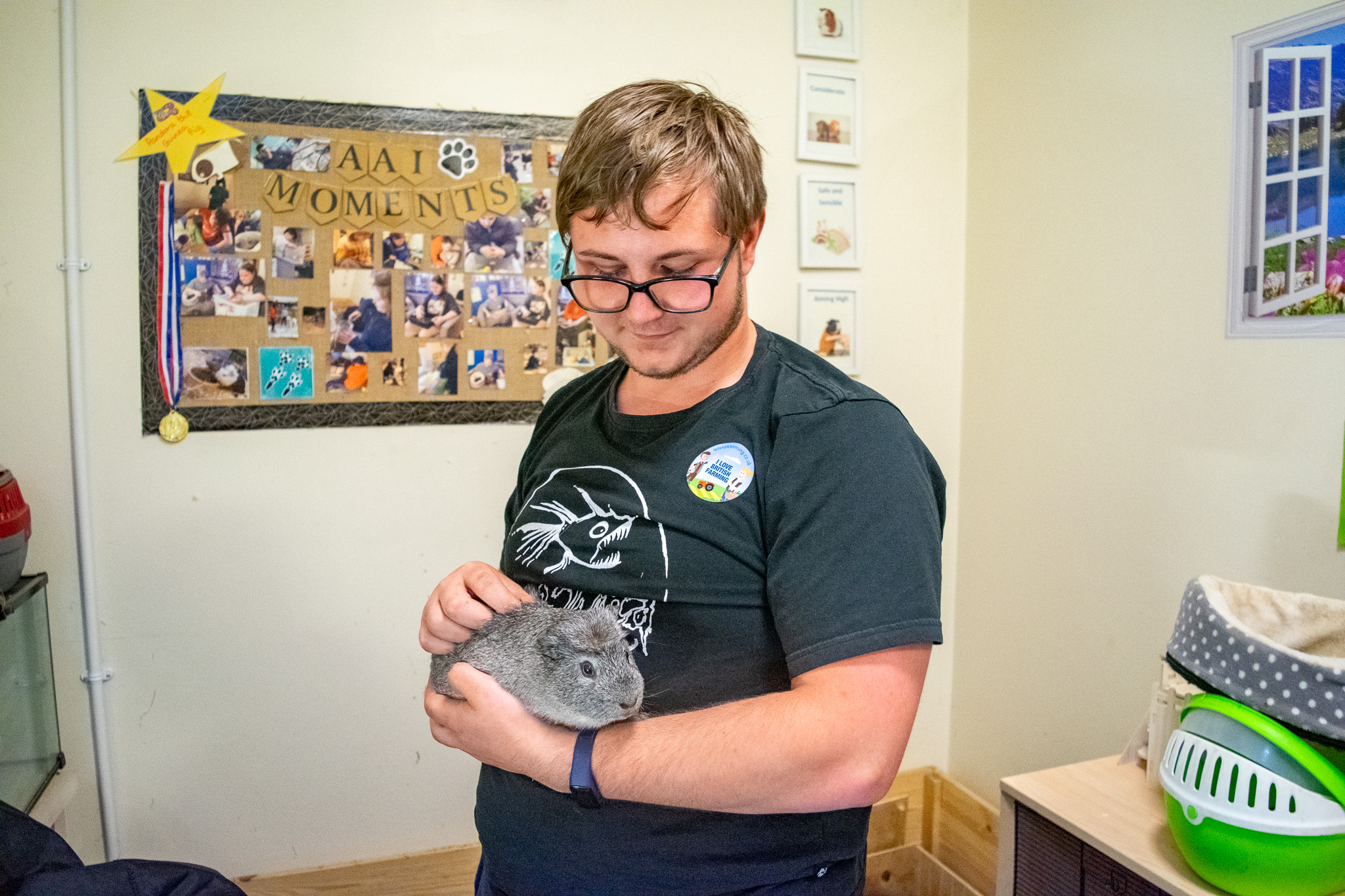 a student holding a guinee pig