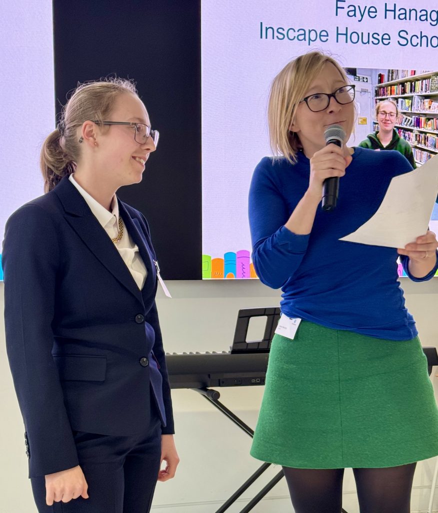 Faye is on stage, smiling as she receives her certificate.