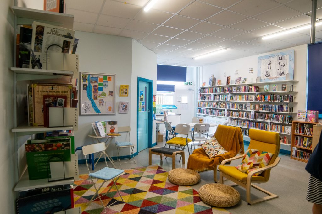 inscape library with shelves of books and chairs and tables in the middle