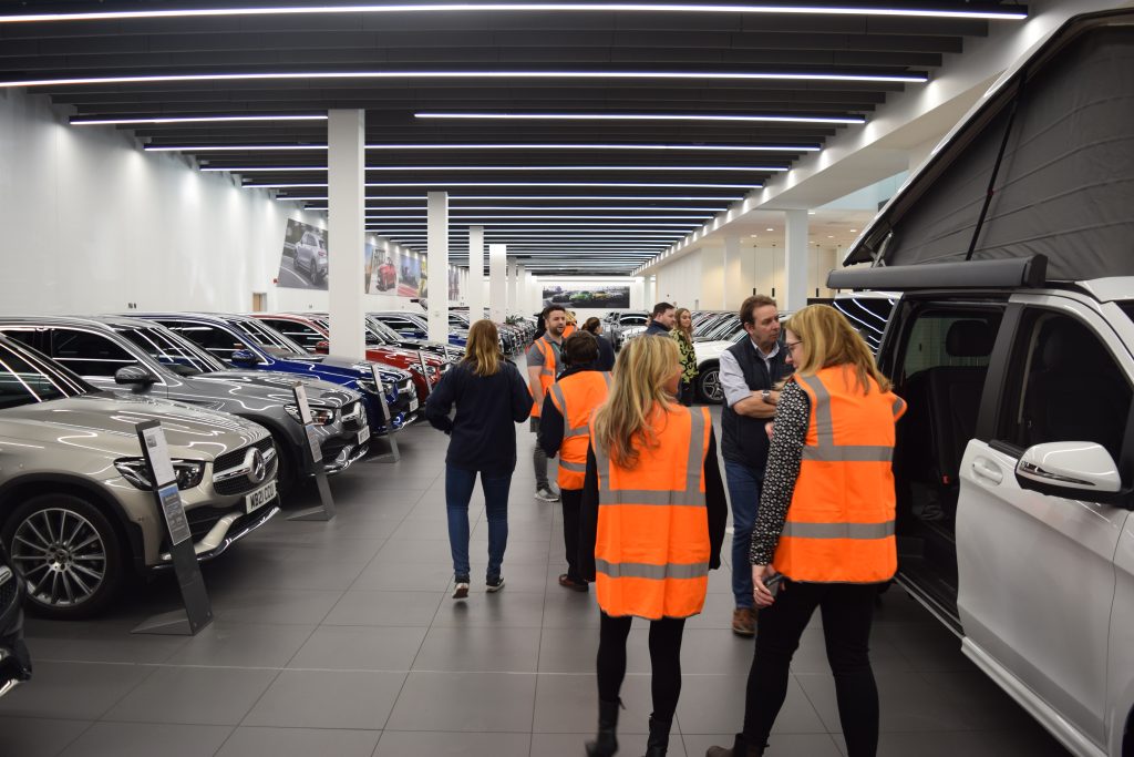 A group of students walking around the showroom.